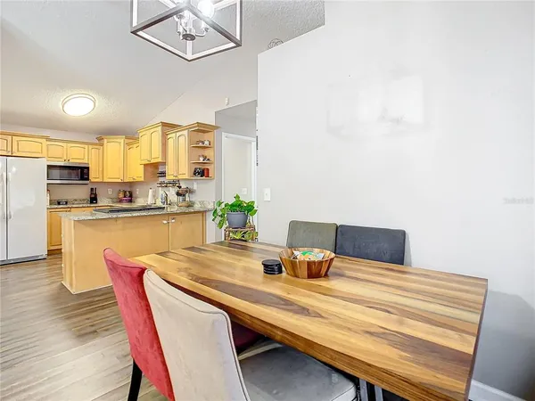 a dining room with furniture and wooden floor