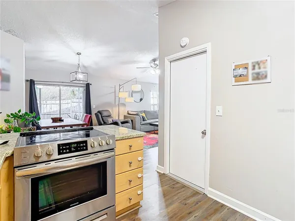 a kitchen with a stove and a wooden floor