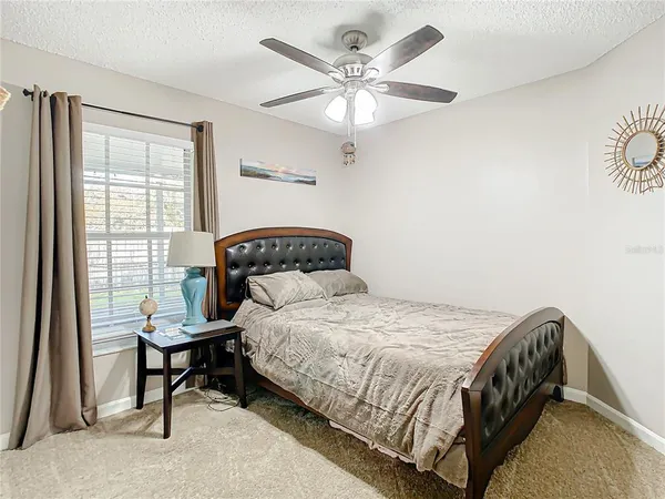 a bedroom with a large bed and a window