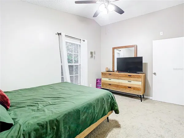 a bedroom with a bed and a chandelier