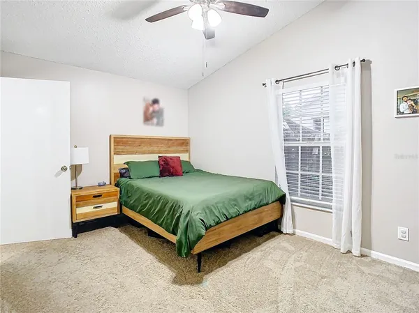 a bedroom with a large bed and a chandelier