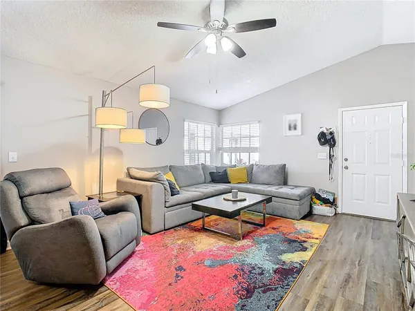 a living room with furniture and wooden floor