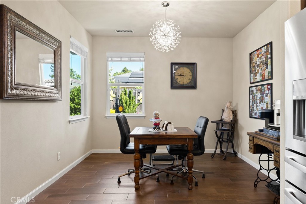 320 Sonora Lane Chico, CA 95973 - Photo 6 of 21 a view of a dining room with furniture wooden floor and a chandelier