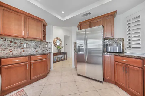a kitchen with stainless steel appliances granite countertop a refrigerator and cabinets