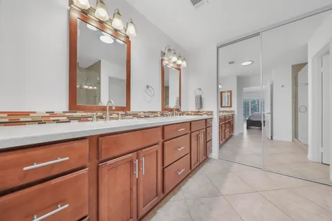 a spacious bathroom with a granite countertop sink mirror and a