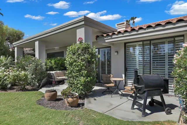 a view of a patio with a chairs and plants