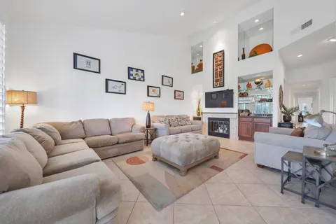 a living room with fireplace furniture and a flat screen tv