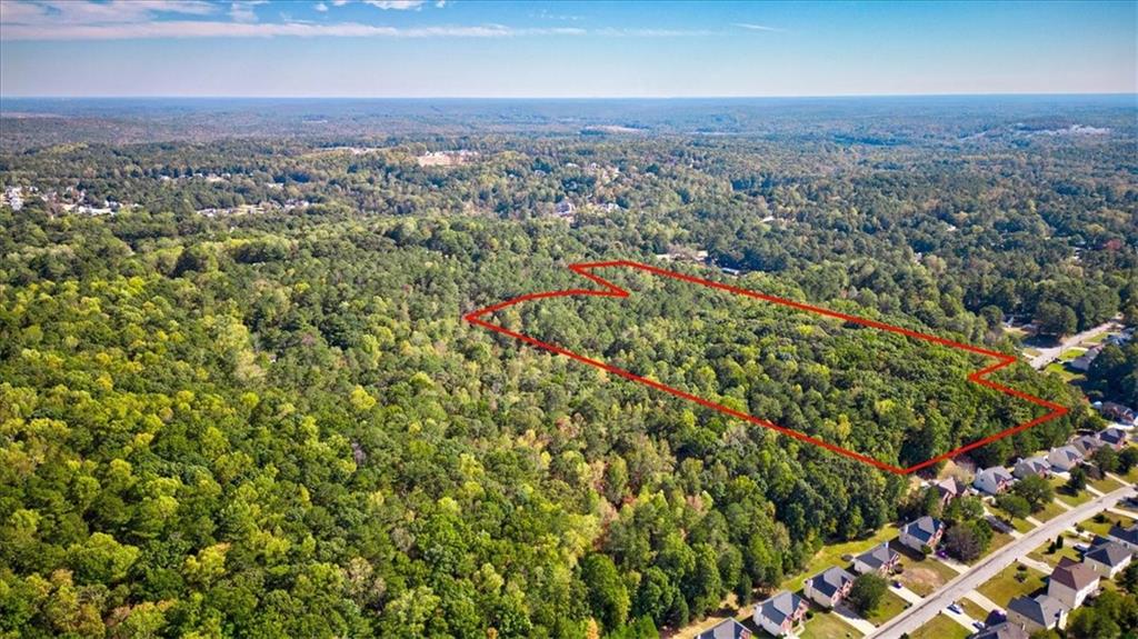 an aerial view of residential house with green space