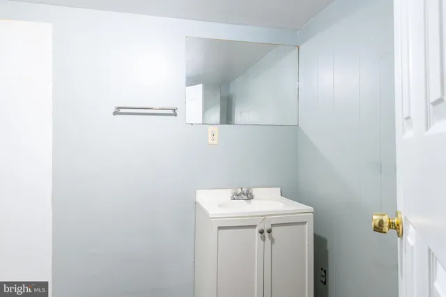 a bathroom with a sink and mirror