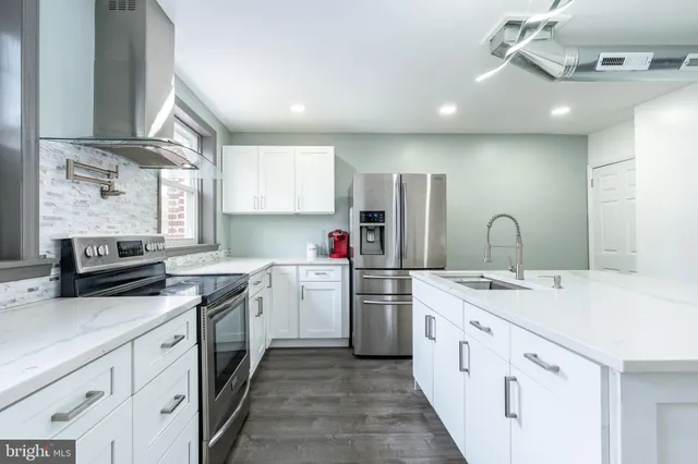 a kitchen with a sink stove and cabinets