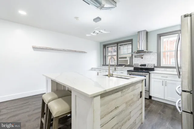 a kitchen with a sink cabinets and window