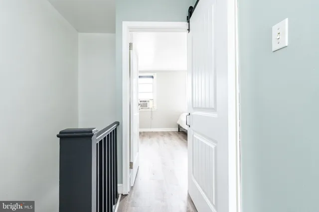 a view of a room with wooden floor and a bathroom