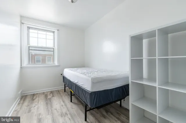 a bedroom with a bed and a window