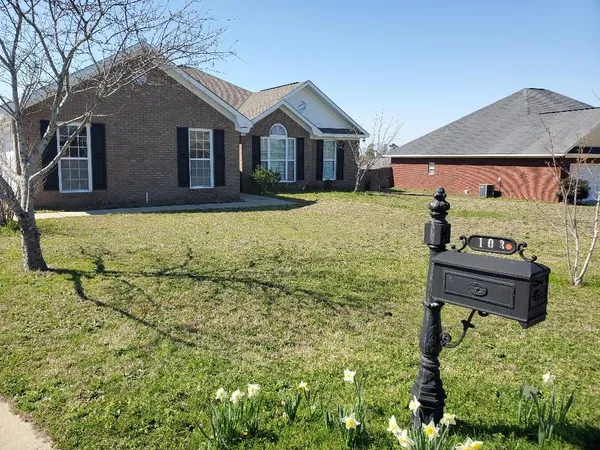 a front view of a house with a yard