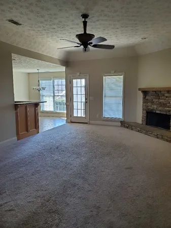 a view of an empty room with a fireplace