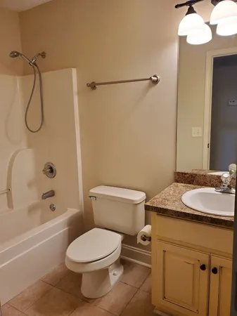 a bathroom with a sink vanity mirror and toilet