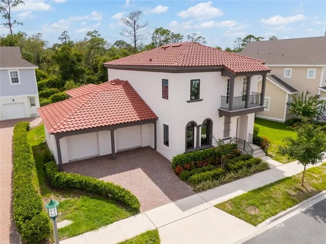 an aerial view of a house with a garden and lake view