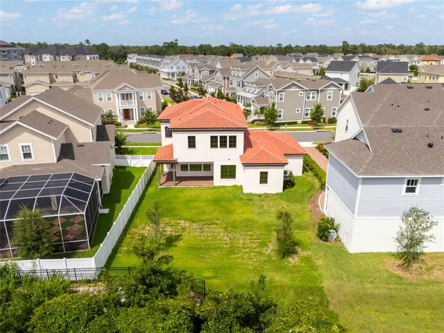 an aerial view of a house with a garden and swimming pool