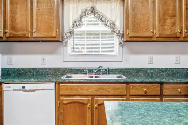 a kitchen with stainless steel appliances granite countertop a cabinets and a counter top space