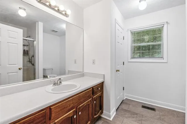 a bathroom with a sink a vanity and a mirror
