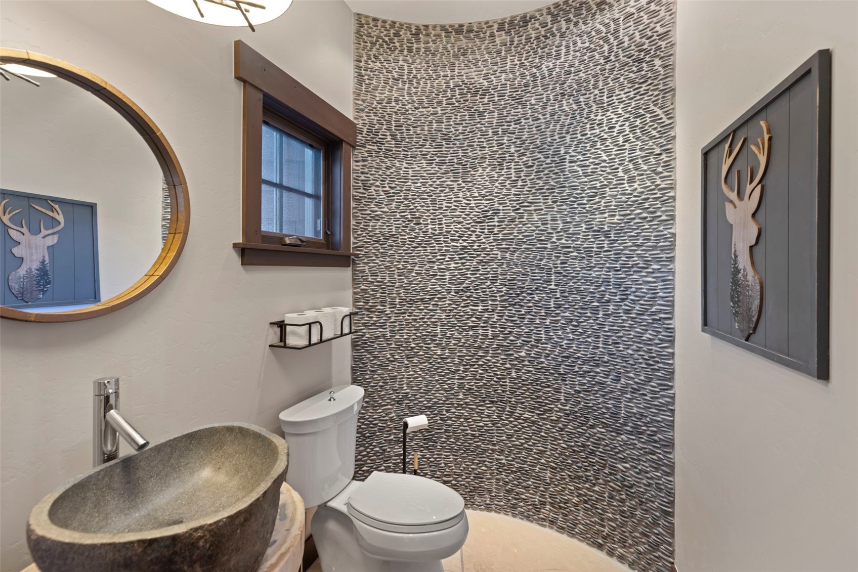 436 Gold Run Road Breckenridge, CO 80424 - Photo 11 of 50 Powder room with a stone sink and pebble accent wall.