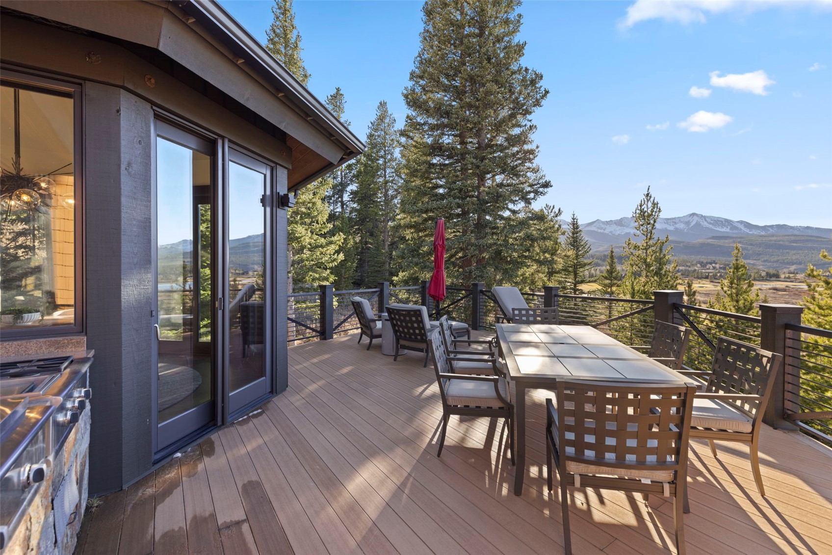 436 Gold Run Road Breckenridge, CO 80424 - Photo 26 of 50 Built-in outdoor kitchen featuring a 2-burner gas stovetop, a flattop grill, and a standard gas grill.