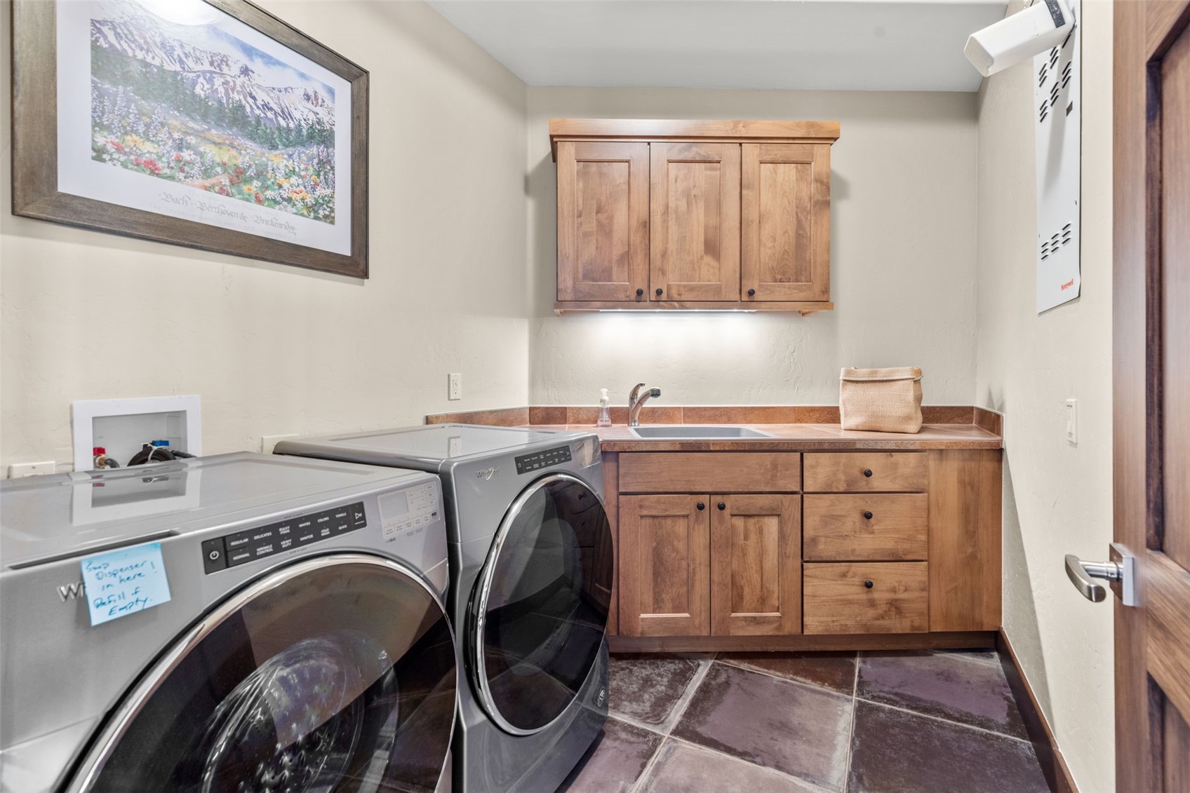 436 Gold Run Road Breckenridge, CO 80424 - Photo 35 of 50 Laundry room equipped with a sink and plenty of cabinet storage.