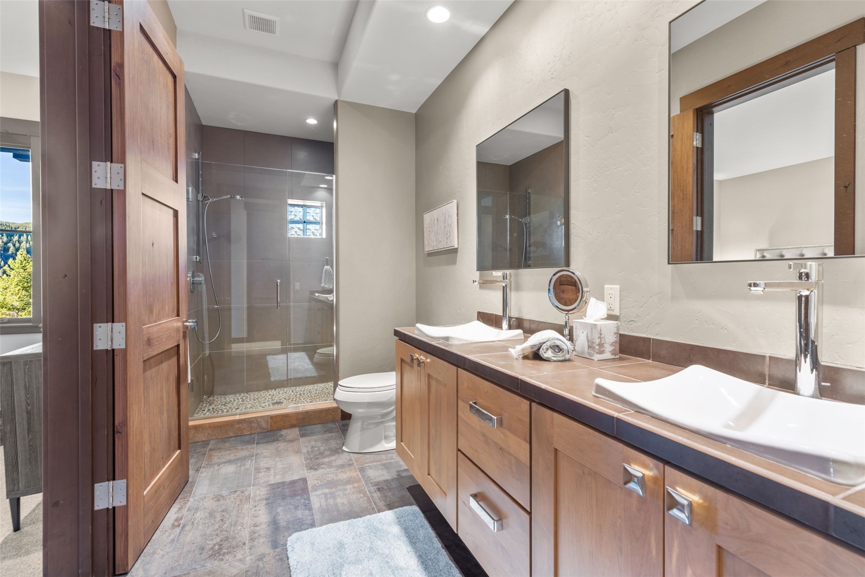 436 Gold Run Road Breckenridge, CO 80424 - Photo 46 of 50 Shared 4th bathroom. New tile floors, pebble shower floors, and dual sinks providing all users with ample space.