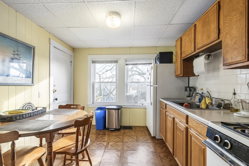 78 R Mt Vernon Street Somerville, MA 02145 - Photo 11 of 32 a kitchen with stainless steel appliances granite countertop a sink a stove and a refrigerator