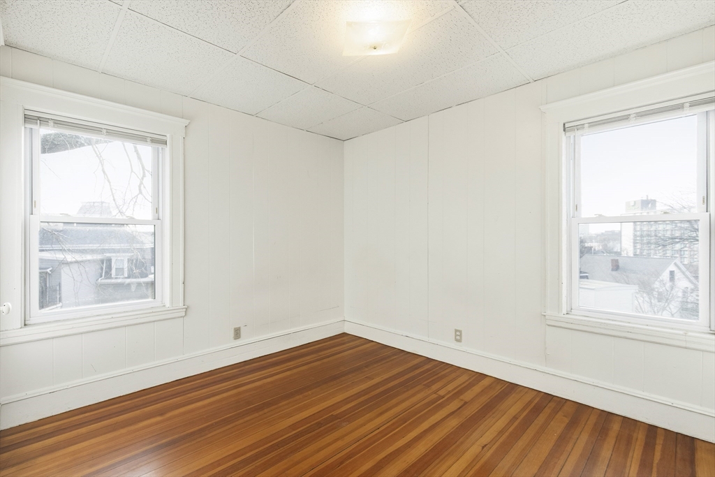 78 R Mt Vernon Street Somerville, MA 02145 - Photo 14 of 32 an empty room with wooden floor and windows