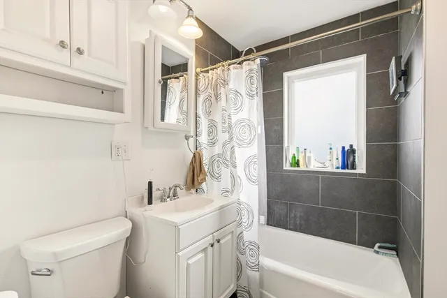 a kitchen with stainless steel appliances kitchen island granite countertop a table chairs and white cabinets