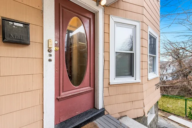 a view of a dining room with furniture and a window