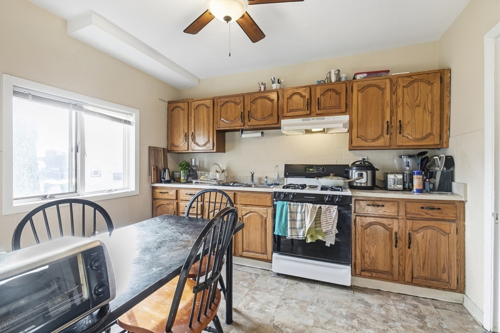 78 R Mt Vernon Street Somerville, MA 02145 - Photo 6 of 32 a kitchen with stainless steel appliances granite countertop a stove top oven a sink dishwasher and cabinets with wooden floor