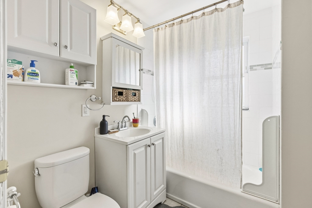 78 R Mt Vernon Street Somerville, MA 02145 - Photo 9 of 32 a bathroom with a sink a toilet and shower curtain