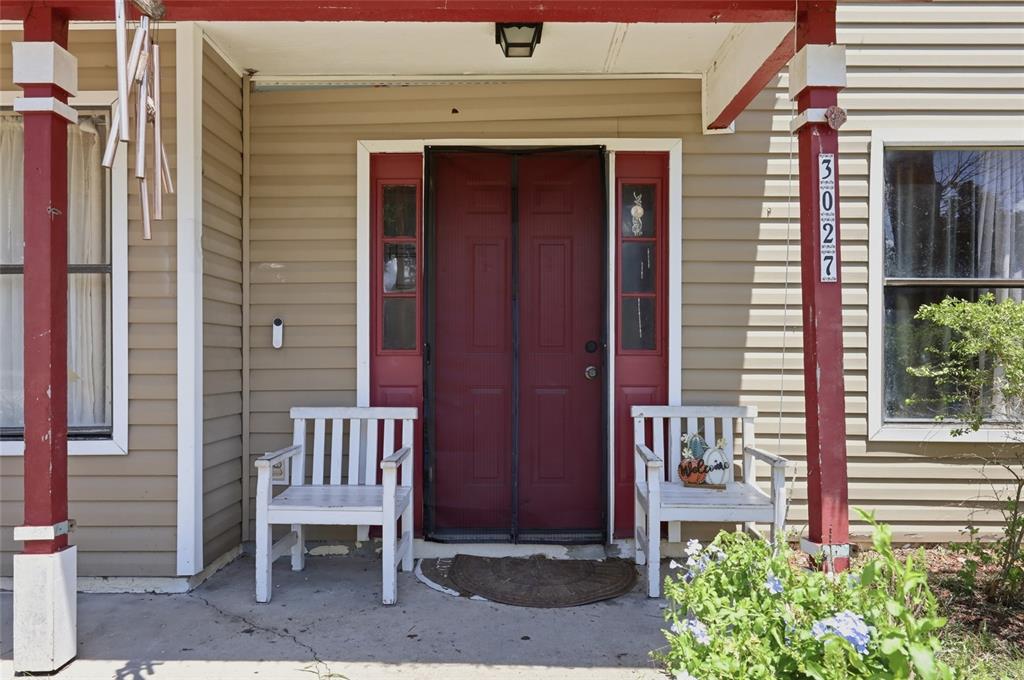 3027 Queens Gate Road Orlando, FL 32818 - Photo 5 of 6 a front view of a house with a bench