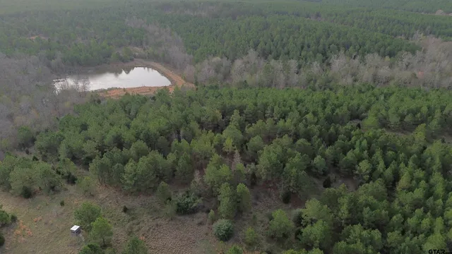 an aerial view of a house with outdoor space