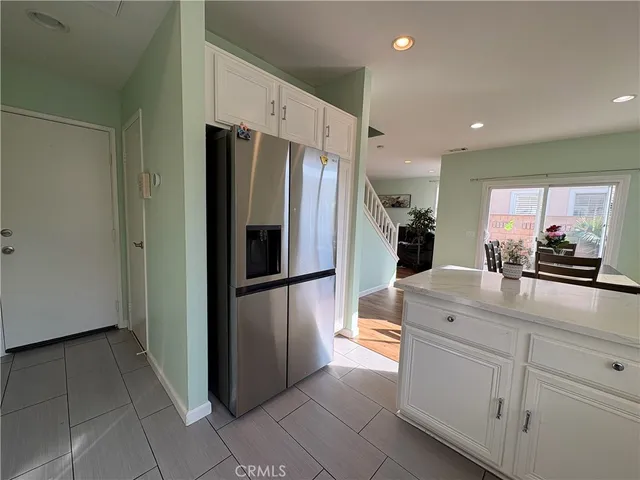 a kitchen with stainless steel appliances granite countertop a sink and a white cabinets