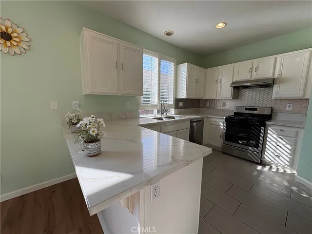 a kitchen with stainless steel appliances a refrigerator sink and microwave