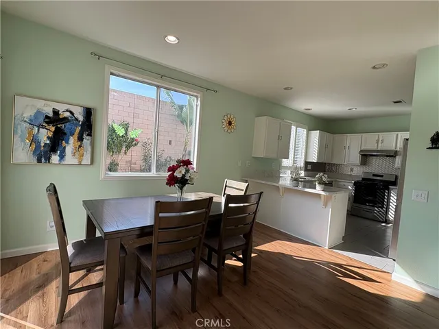 a view of a dining room with furniture window and wooden floor