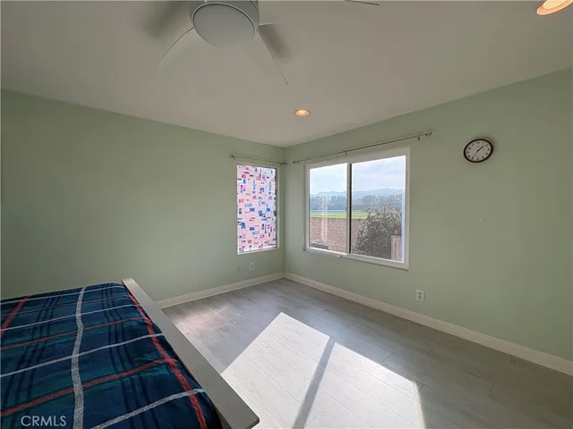 a living room with furniture and a painting on the wall