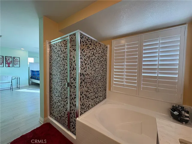 a bathroom with a bathtub and a shower