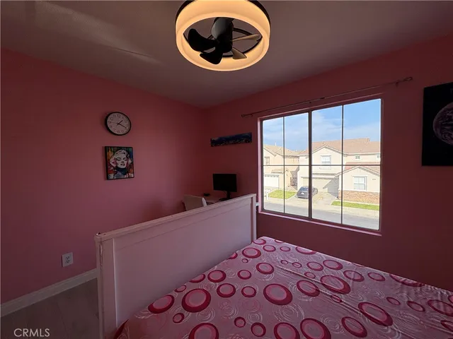 a bed room with a bed and a chair