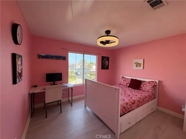 a view of a workspace with furniture and wooden floor
