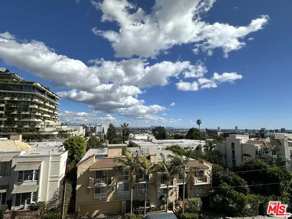 a view of a kitchen with kitchen island stainless steel appliances refrigerator stove microwave and cabinets