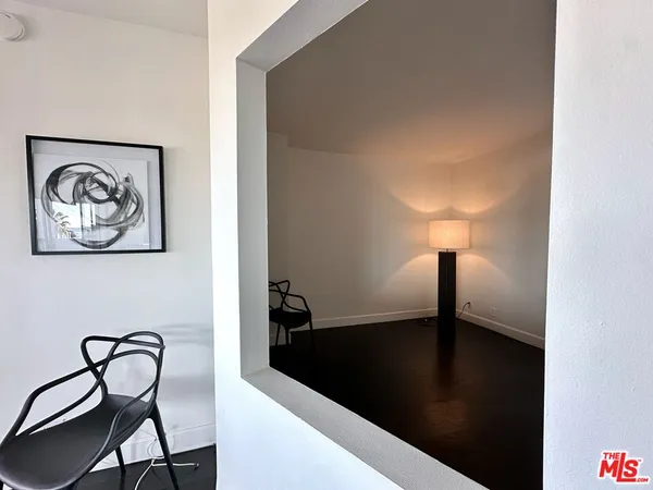 a view of a livingroom with furniture and a lamp