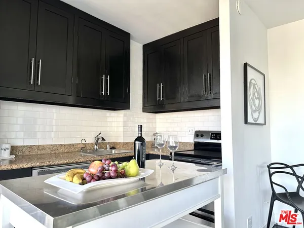 a kitchen with a sink and a stove top oven