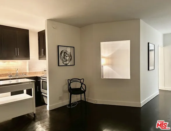 a view of a workspace with furniture and wooden floor
