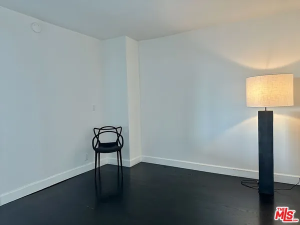 a room with a chair and wooden floor