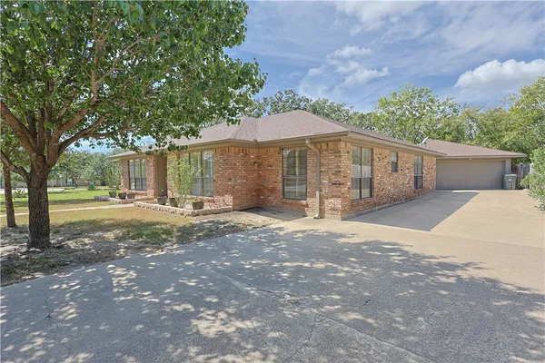 a view of a backyard with large trees