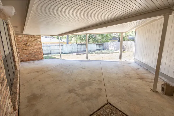a view of an empty room with windows